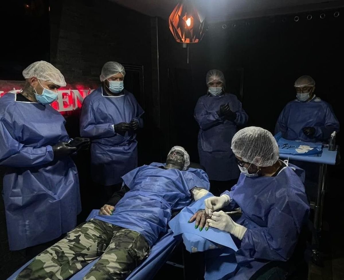 Anthony Loffredo laying on a table during a surgical procedure, Photo Credit: the_black_alien_project/Instagram